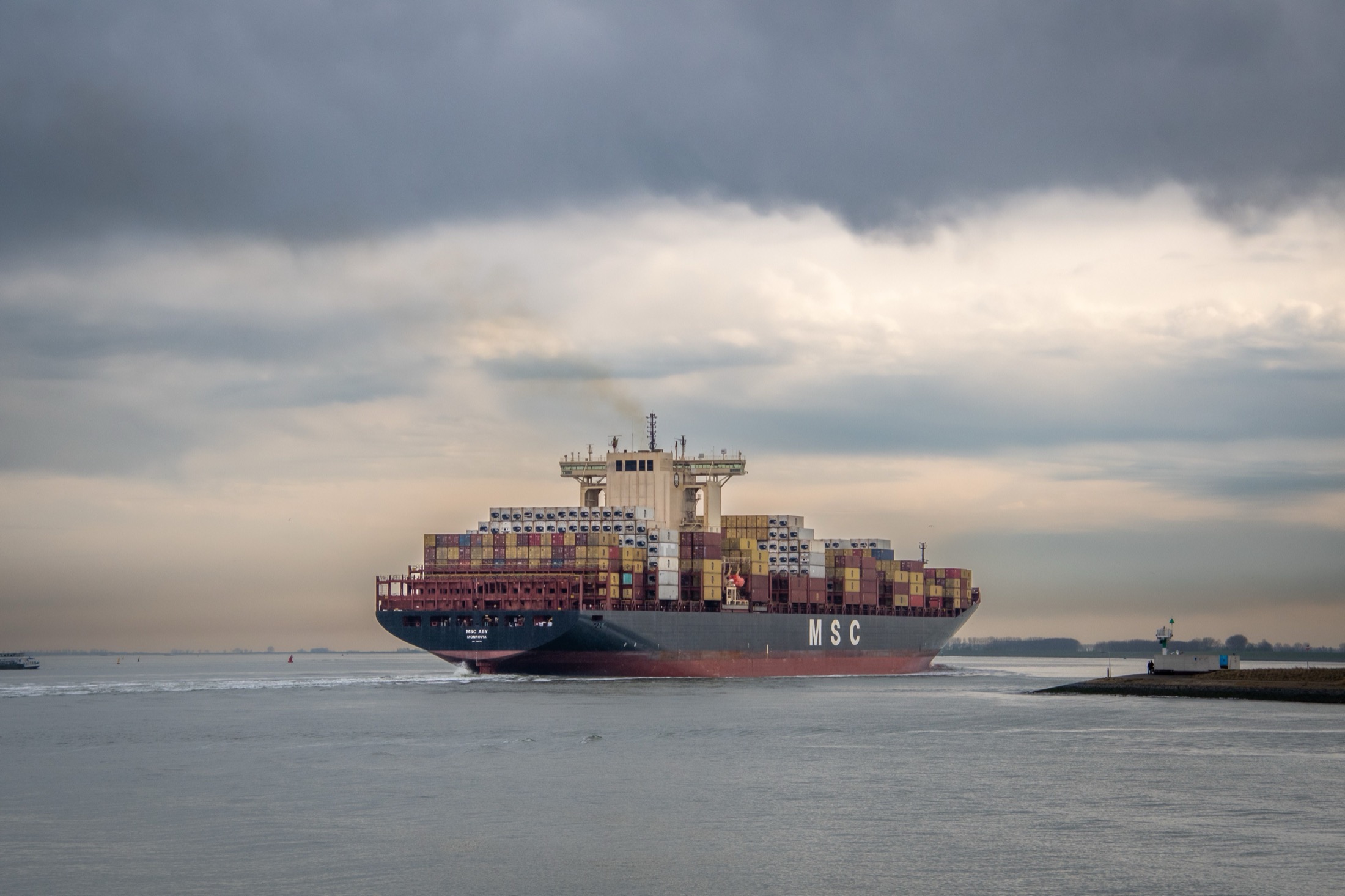Cargo ship moving through cloudy weather